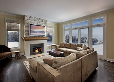 Lopi gas insert in stone fireplace with lakehouse sofa